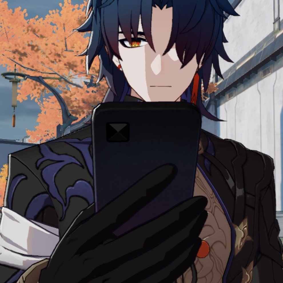 an anime character with black hair and red eyes is looking at a phone in a serious expression. he is wearing black and gold clothing with a blue design and a red earring. the background is a blurry image of trees and a white building.