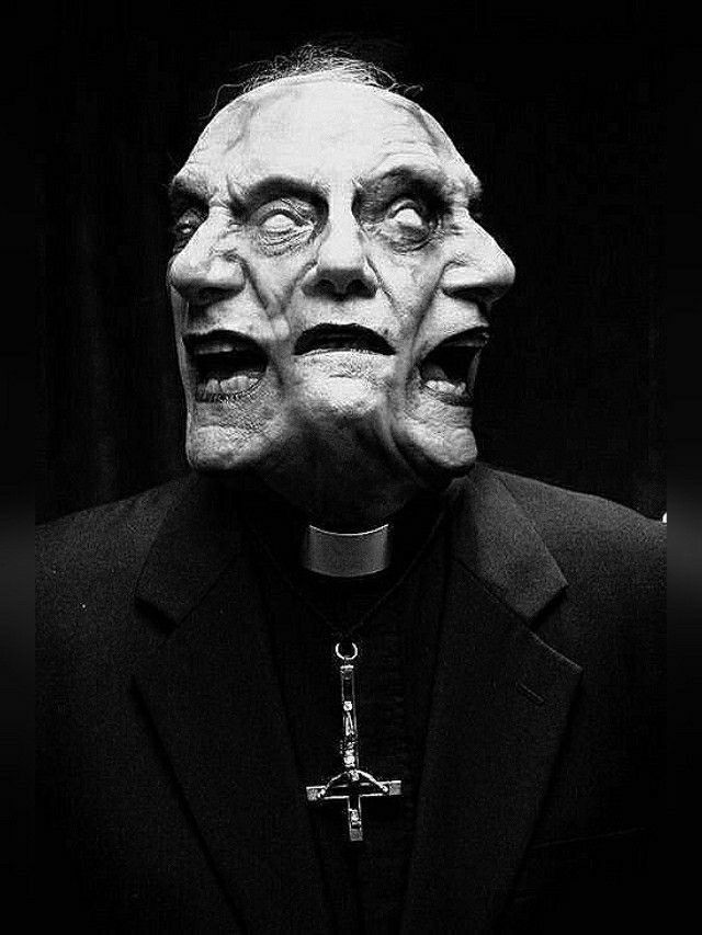 a black and white image of a man with multiple faces, one on each side of his head. he is wearing a black suit jacket and a white priest collar with an inverted cross around his neck. the man has a dark and evil expression on his face with his eyes wide and his mouth open in a scream.