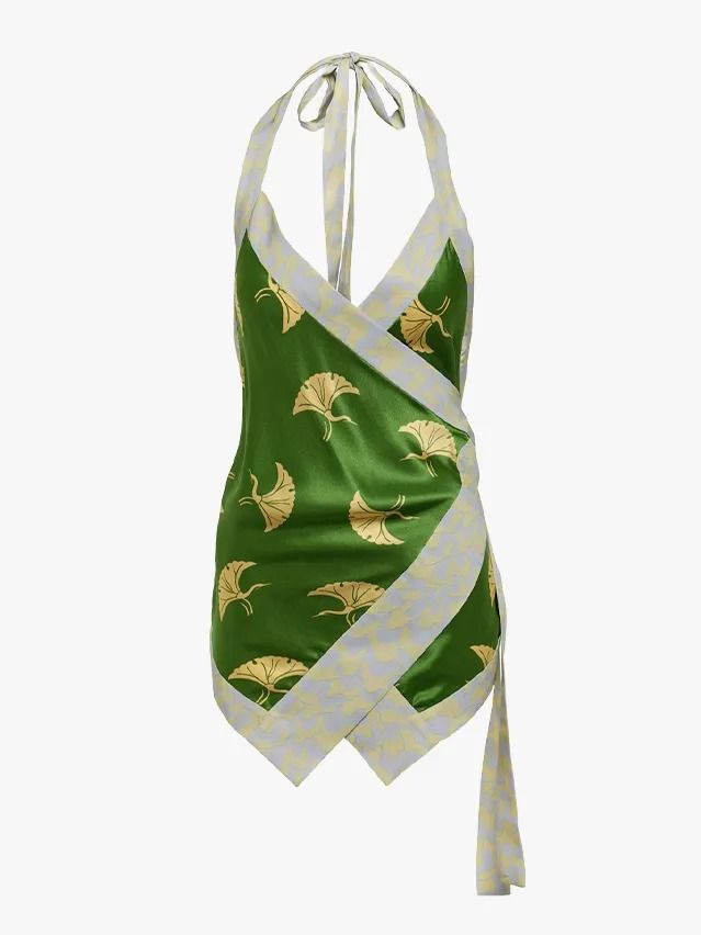 a green halter top dress with gold leaf pattern and a light patterned trim.