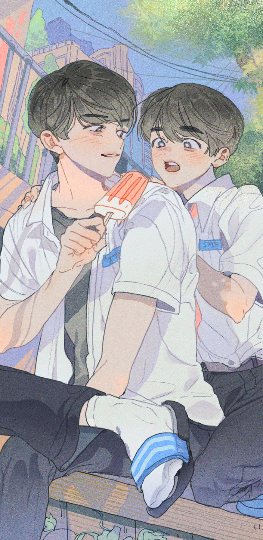 the illustration depicts two young men in a tender moment. the older one, with darker hair and a sly smile, holds a popsicle to the other's lips. the younger one, with his eyes wide and cheeks flushed, appears surprised and delighted. they are both dressed in white shortsleeved shirts and dark pants, suggestive of school uniforms. the background showcases a blurred cityscape with buildings and power lines, bathed in the soft, warm light of a summer day.  the overall feel is intimate, sweet, and romantic, characteristic of the boys love (bl) genre.