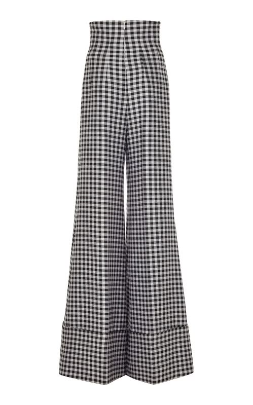 the image shows a pair of highwaisted, wideleg pants in a black and white gingham pattern. the pants have a cuffed hem. they appear to be made of woven fabric.