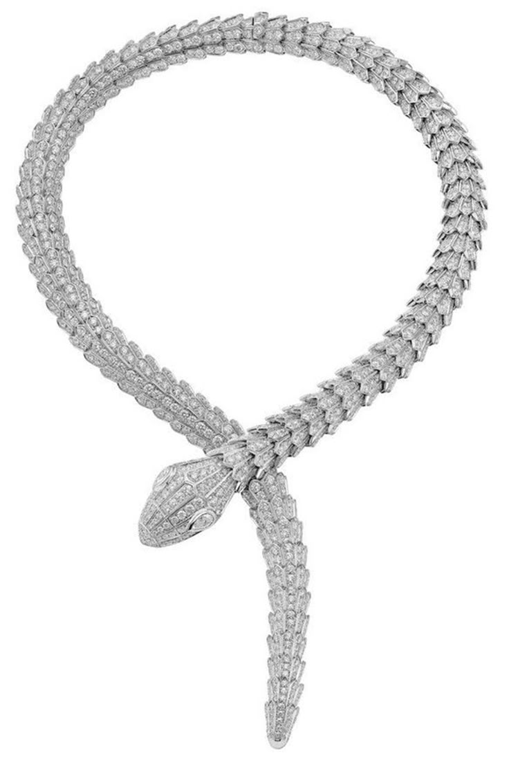 a shimmering white gold snake necklace is displayed on a white background. the necklace is crafted in the shape of a snake, with a detailed head and a winding body. each scale is adorned with sparkling diamonds, giving the necklace a luxurious and eyecatching appearance. the snake's head is intricately designed with diamondset eyes and other features. the necklace is designed to be worn as a statement piece, showcasing the wearer's style and sophistication.