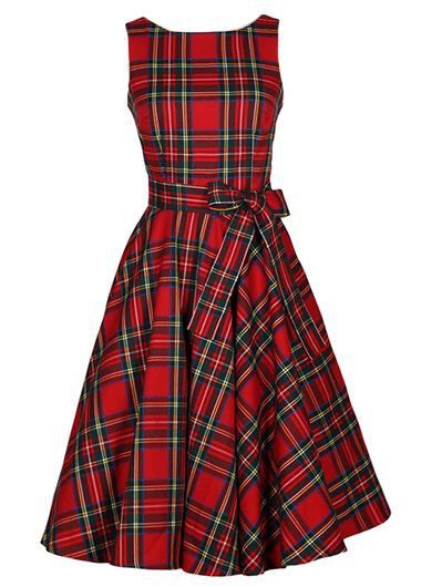 a red plaid dress with a vintage aline silhouette, a sleeveless design, and a belt that cinches the waist. the dress falls to kneelength.
