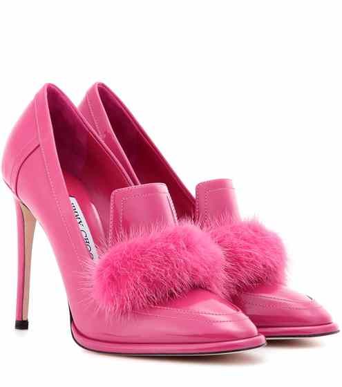 two pink high heels with fur are displayed on a white background.