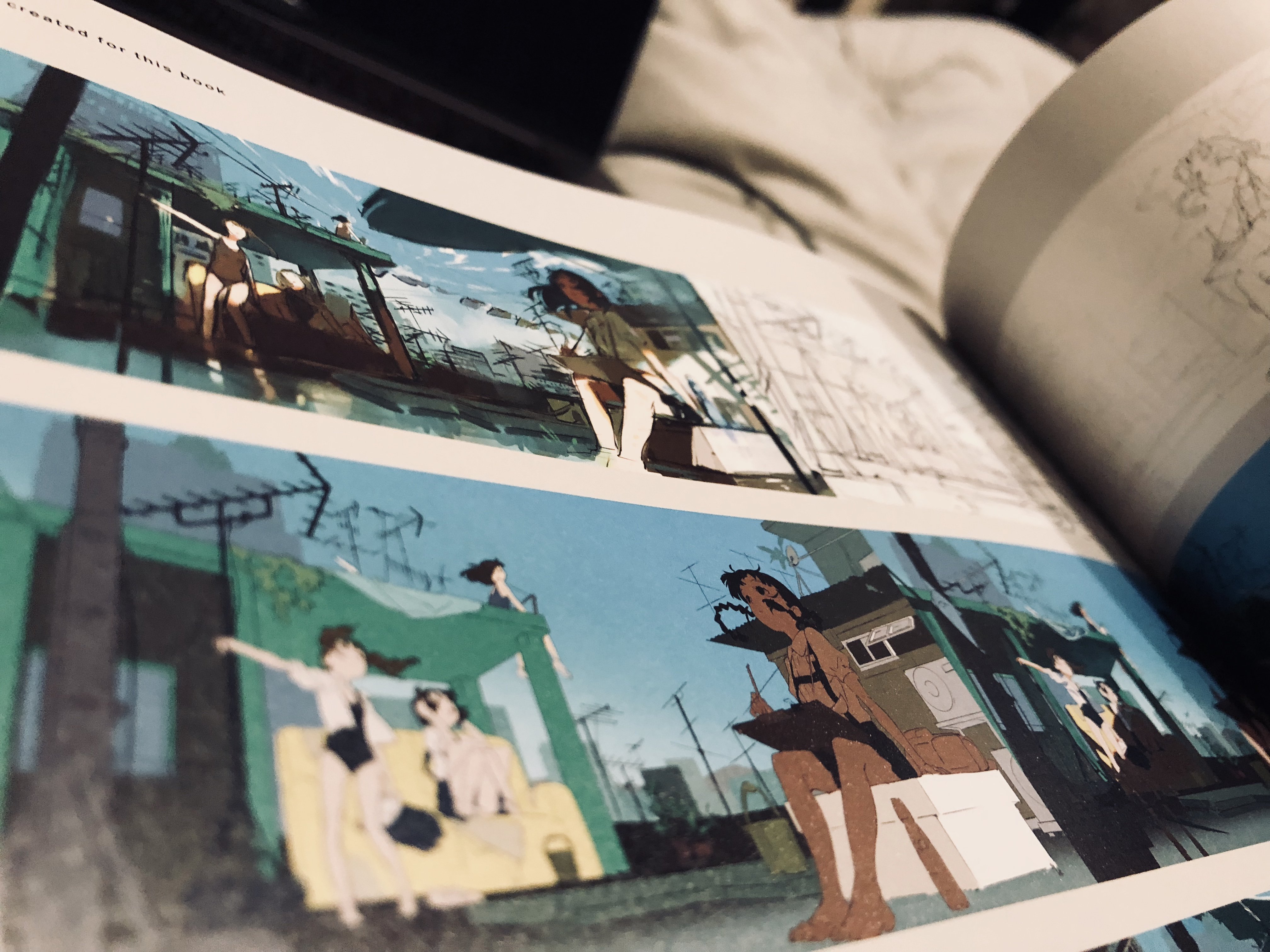 the image showcases two pages from an artbook, likely for an anime or game, featuring concept art for a postapocalyptic cityscape. the art style leans towards a vibrant, slightly stylized aesthetic. the top page presents a panoramic view of rooftops covered in overgrown vegetation and tangled wires, hinting at a society reclaimed by nature.  the bottom page focuses on smaller vignettes of characters going about their lives in this setting: a group of young women relaxing on a rooftop couch, and a lone artist sketching amidst the urban decay. the color palette emphasizes bright blues for the sky, contrasting with the greens of the foliage and warm yellows of the buildings. the overall mood is a mixture of melancholy and a sense of resilience.