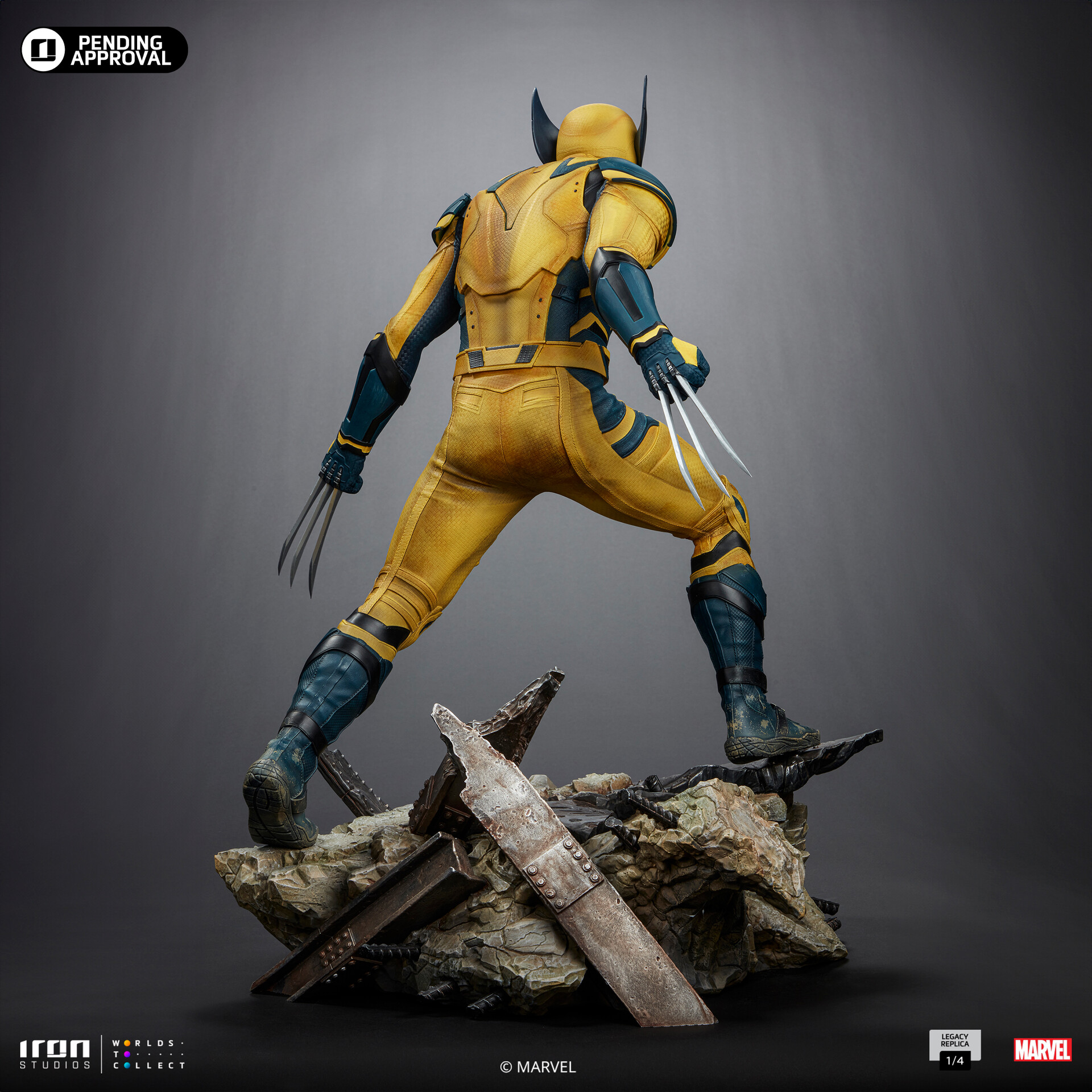 this is a studio shot showcasing the back of an iron studios wolverine statue. the statue captures wolverine in a dynamic pose, perched atop a pile of rubble. he's wearing his classic yellow and blue costume, and his claws are out, ready for action. the lighting is dramatic, highlighting the detail of the sculpt and the texture of his suit and the debris.