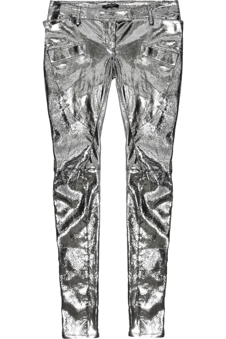 a pair of shiny silver skinny pants are standing upright, with their front facing forward. the pants are metallic and have a creased texture, giving them a textured appearance. the pants are slimfitting and have a standard waistband with belt loops. they are displayed against a solid white background.