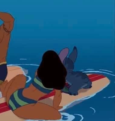 a cartoon image of stitch and lilo from the disney movie lilo & stitch, with stitch perched on a surfboard behind lilo. lilo has dark hair and is wearing a green and blue bikini, while stitch is a blue, furry alien. they're both in the ocean with a blue background.