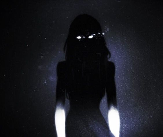 the image showcases a shadowy figure, presumably female, enveloped in darkness. only her piercing white eyes are visible, glowing ominously against the black silhouette. the background is a deep, textured black, enhancing the mysterious and eerie atmosphere.