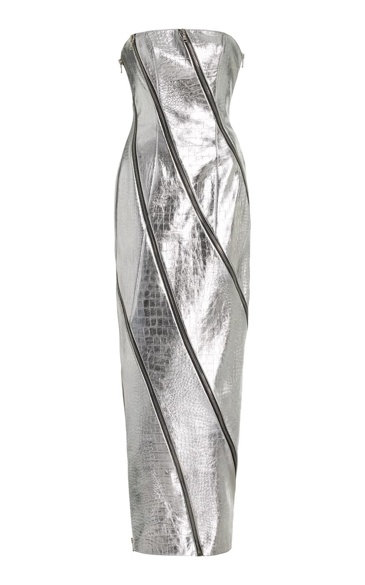 a strapless silver metallic dress is presented on a white background. the dress appears to be made of a textured material and features darkcolored zippers that run diagonally across the dress's surface. the design gives the garment a modern, edgy look.