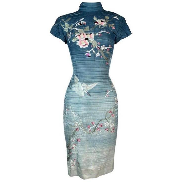 a blue, vintagestyle cheongsam dress is displayed. it has a mandarin collar, short sleeves, and falls to about kneelength. the dress features a gradient of blue, lighter towards the bottom, with horizontal textured lines throughout. embroidered floral patterns and a crane design embellish the dress.