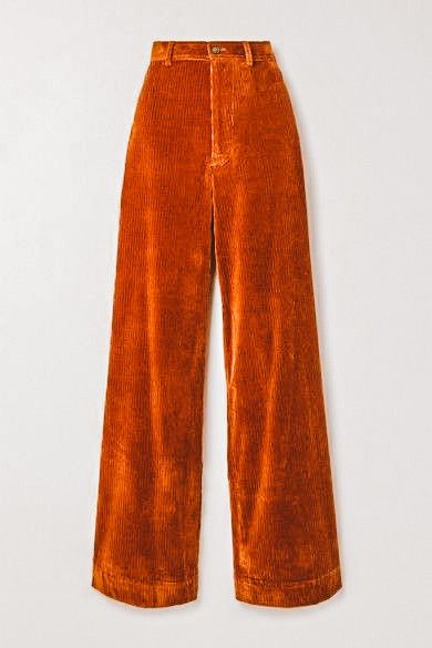 a pair of orange corduroy pants with a wide leg cut is displayed against a plain background. the pants are neatly folded, showcasing their texture and color. the lighting is wellbalanced, allowing the details of the corduroy fabric to be clearly seen. the overall composition is simple and focuses on the pants themselves.