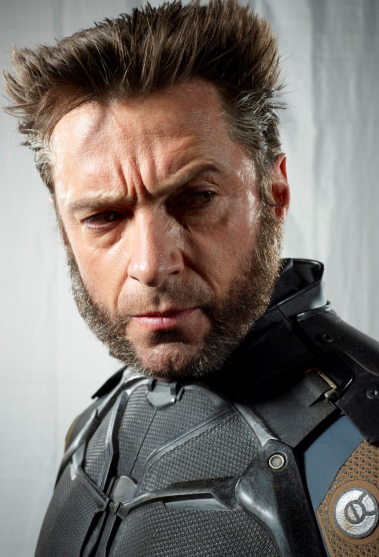 a closeup shot of hugh jackman as wolverine in his xmen costume. he is scowling and has a prominent beard. the focus is on his face and the detail of his costume.