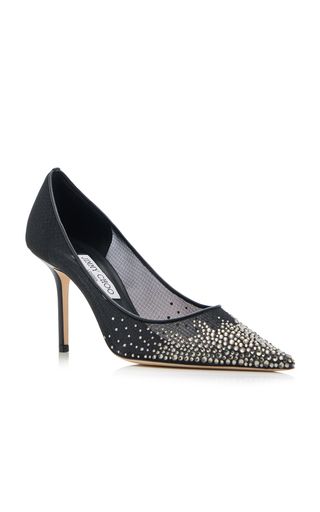 a pair of black jimmy choo heels with silver embellishments on a mesh fabric upper. the shoes have a pointy toe and a stiletto heel.  the heels are sitting on a white background.