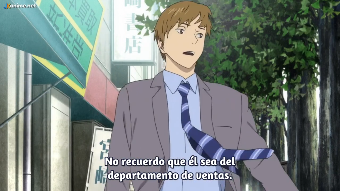 an adult anime male is looking to the left and wearing a grey suit, blue tie, and white collared shirt. he appears confused as if lost. he is standing on a city sidewalk in front of buildings and trees.```