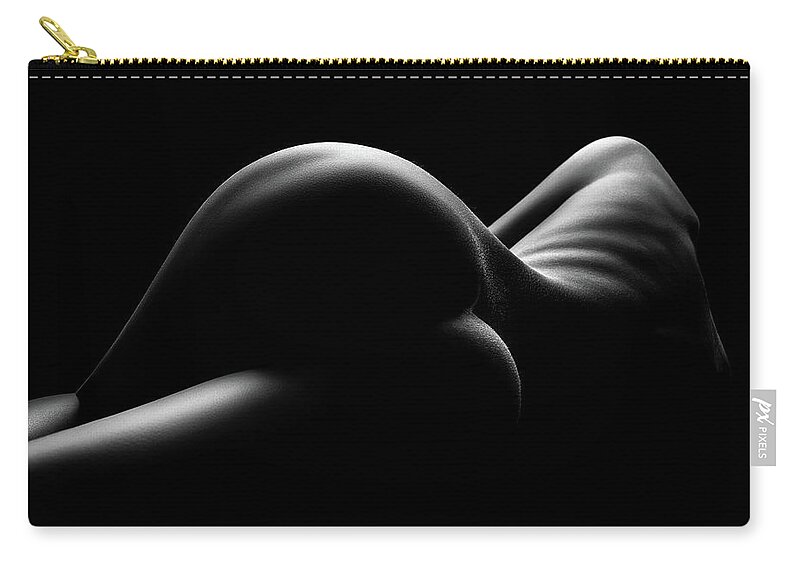 the image is a black and white closeup photograph of a woman's nude back and buttocks.  the lighting is dramatic, using strong chiaroscuro (the strong contrast between light and dark) to highlight the curves and textures of the body.  the woman's form is presented in a stylized, almost abstract manner, focusing on the shapes and shadows rather than explicit detail. the overall mood is sensual and evocative.  the background is completely dark, drawing all attention to the subject's body.