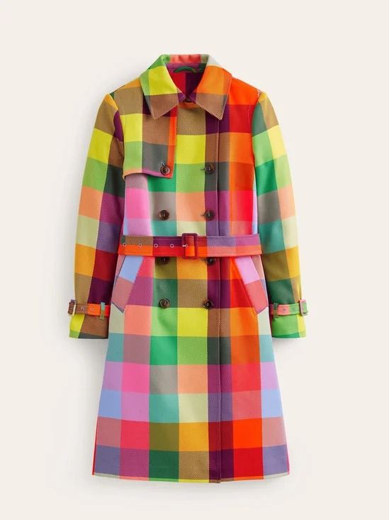 a vibrant, checkered trench coat with a belt is displayed against a neutral background. the coat features a doublebreasted design with visible buttons, a collar, and a belt cinching the waist. the colorful pattern consists of large squares in various hues, including red, orange, yellow, green, blue, and pink. the coat's overall appearance is eyecatching and fashionable.