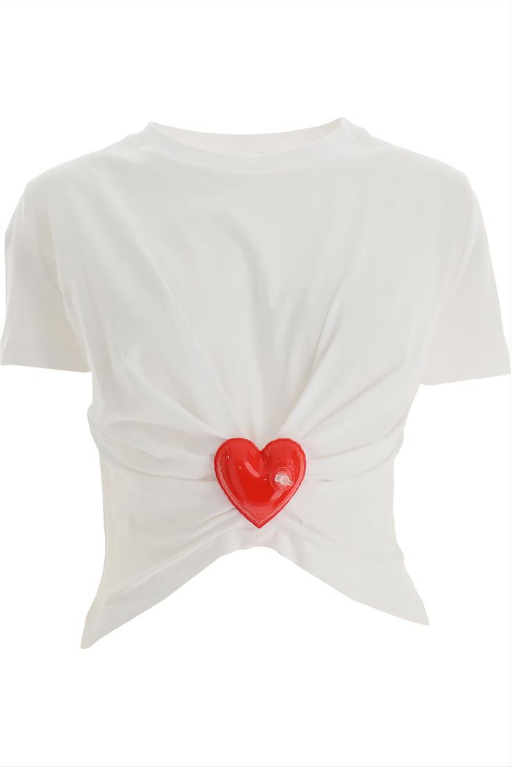 a white, shortsleeved tshirt is presented against a plain white background. the shirt features a unique design with a knotted front detail. at the center of the knot, a shiny red heartshaped applique is attached. the heart is slightly raised, giving it a threedimensional appearance. the shirt's design is simple yet eyecatching due to the heart detail and the knotted front. the fabric appears soft and slightly wrinkled, suggesting a lightweight material. the overall impression is a casual yet stylish garment.