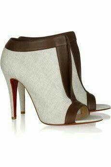 the image shows a pair of women's elegant high heels. the shoes are peeptoe slingbacks with a beige fabric upper and brown leather accents.  the heels are stiletto, and the shoes feature a platform.  the shoes are displayed on a white reflective surface.  the style suggests a designer shoe, possibly christian louboutin, given the red soles which are partially visible, but this is not confirmed.