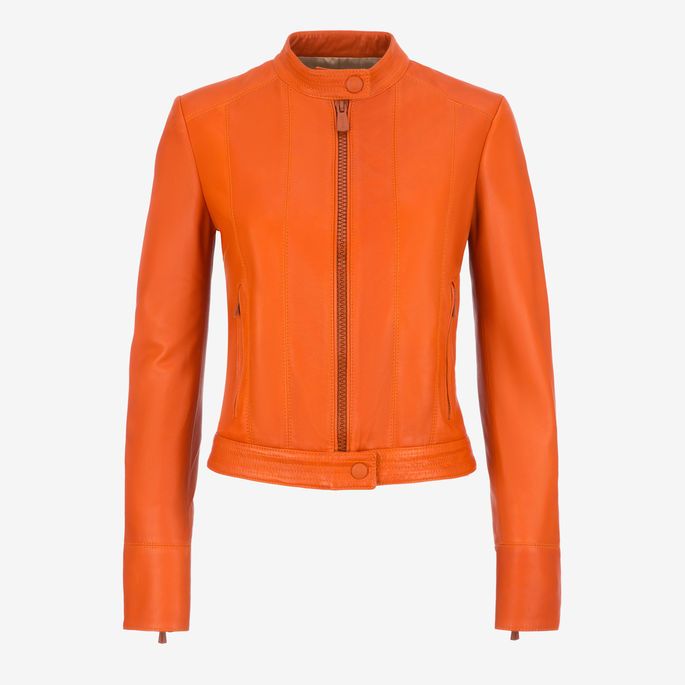 a women's fitted orange leather jacket with a mandarin collar and a zipper closure is centered on a white background. the jacket has long sleeves with buttoned cuffs, a straight hem, and a single button closure at the bottom. there are vertical seams on the front and small welt pockets at the waist.