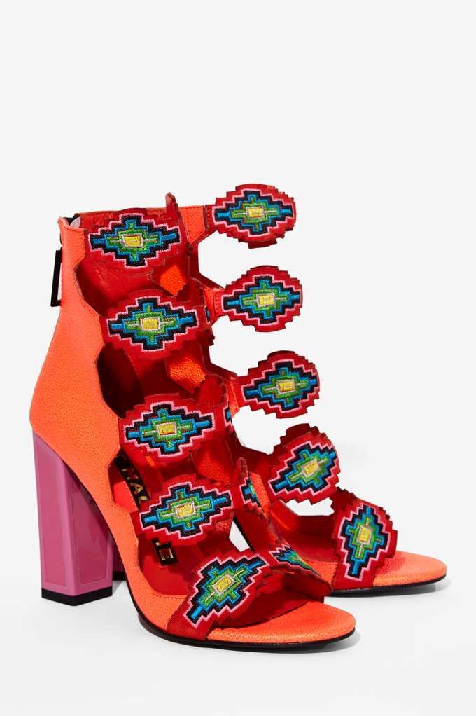 a pair of women's red and orange platform sandals with colorful embroidery. the sandals have a block heel and multiple straps.  the shoes are a stylish and comfortable option for summer.