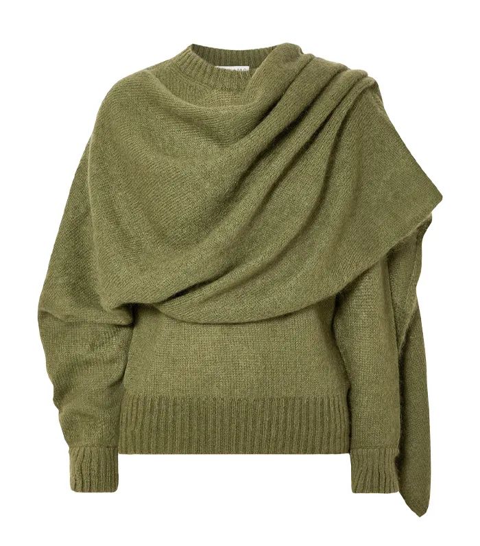 a closeup of a green draped knit sweater, with a relaxed, oversized fit. the sweater is soft and comfortable and perfect for fall and winter. the style is casual and chic and looks great with jeans or a skirt. the sweater is made from a blend of wool and cashmere and is incredibly soft. it's the perfect layering piece for cooler weather.