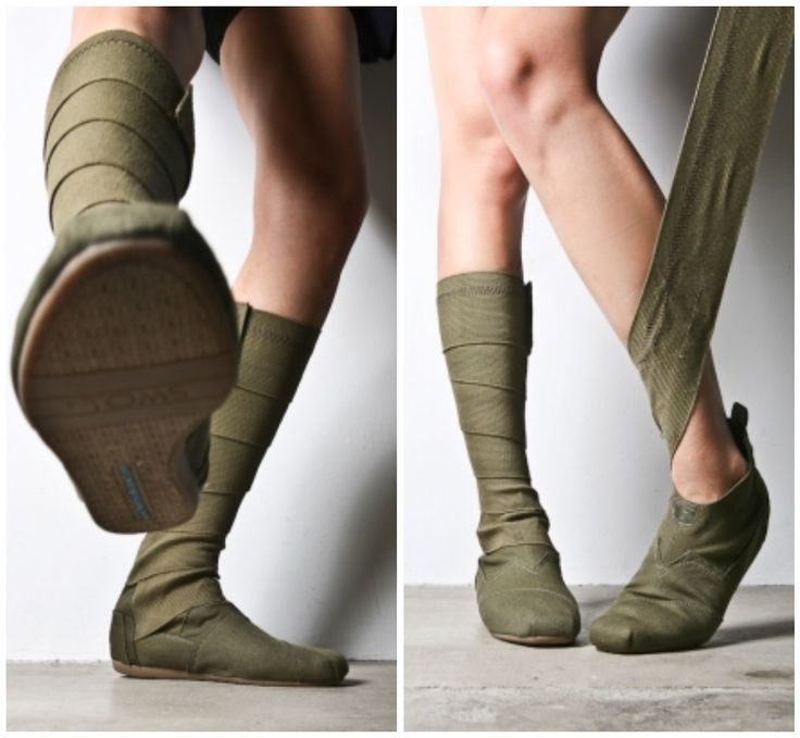 a split image of a model wearing military green ankle boots. the left side of the image shows the model from the side, with the boot on the right foot in closeup detail. the right side of the image shows the model from the back, with both boots on.  the boots are made of a soft, khakicolored fabric, and they have a simple, minimalist design. the model is wearing the boots with a pair of casual jeans.