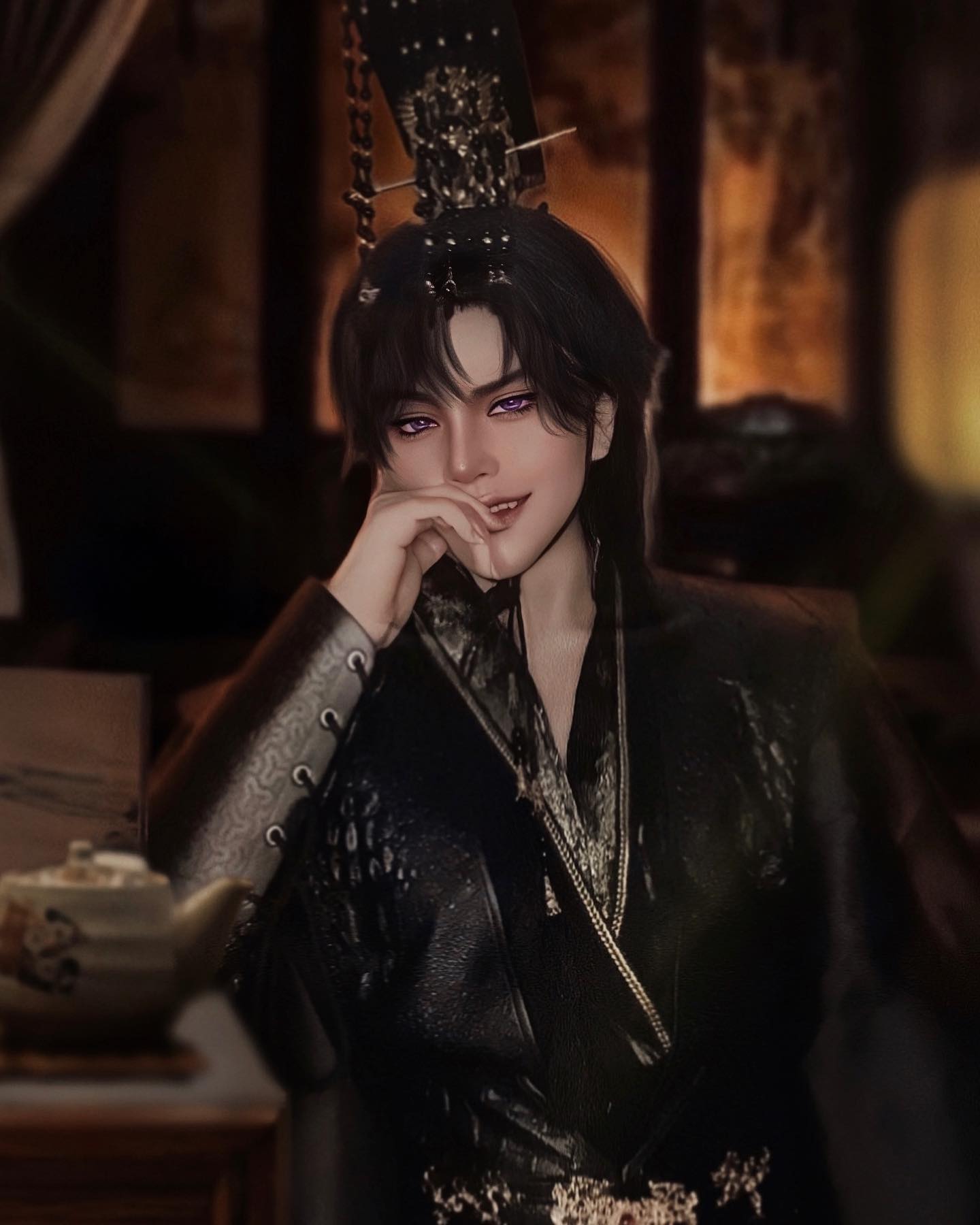 a man wearing a black leather costume with gold and silver accents, sitting in a dimly lit room with a teapot and teacup on a table to his side. he is smiling subtly, his eyes are purple and he has a crown on his head. the background is blurred and dark.