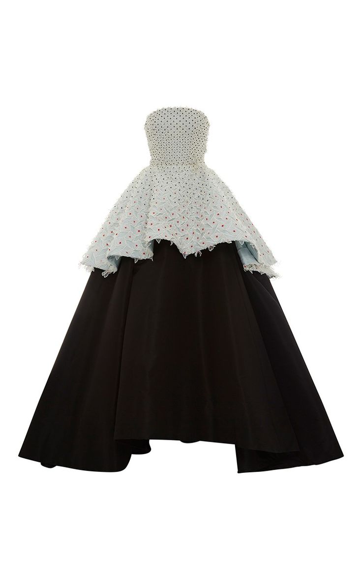a black and white strapless gown with a highlow hemline. the top portion of the dress is white tulle with red embellishments. the skirt is black.