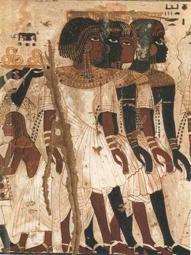 the image shows a fragment of an ancient egyptian tomb painting. it depicts a procession of people, likely servants or officials, walking towards the right. the figures are painted in profile with stylized features and elaborate costumes. they are adorned with jewelry and carry various objects. the scene is rendered in a muted palette with earthy tones and hints of red and ochre.  the background is a plain beige color, typical of egyptian tomb paintings. the overall impression is one of solemn grandeur and ritualistic formality.