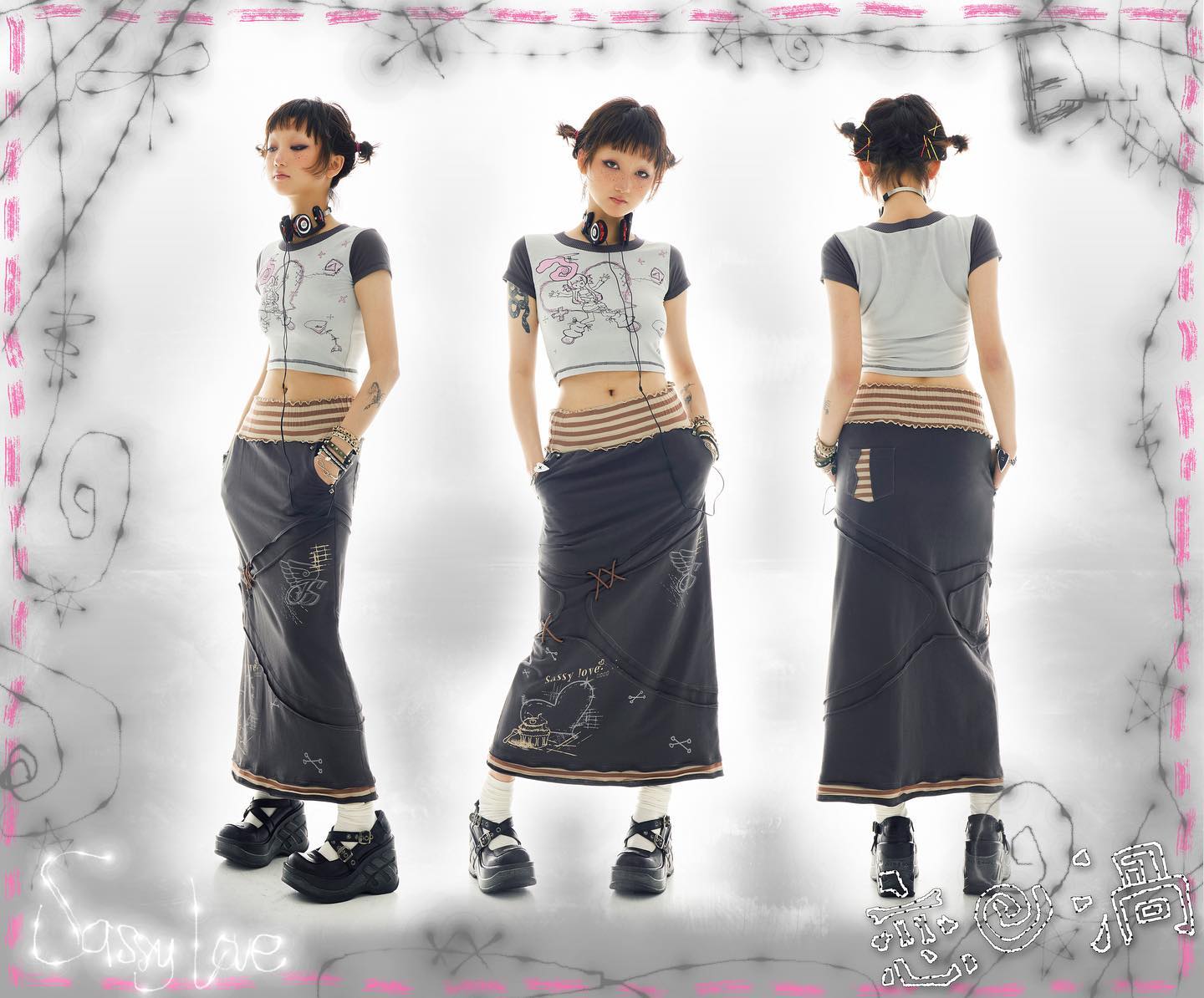 the image shows a model showcasing a dark gray long skirt with brown accents and a patchwork design. the skirt is paired with a light gray cropped top featuring a cartoon graphic. the model is wearing black platform shoes and headphones, adding to the overall grungealternative aesthetic. the background is decorated with pink scribbles and the brand name "sassy love" is visible at the bottom left corner. the image showcases three different views of the model (front, back, and side) and the outfits.