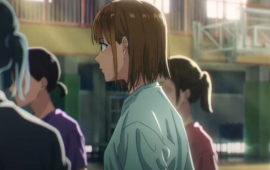 a closeup profile view of an anime girl with short brown hair, wearing a teal shirt, standing in a gymnasium. the background is slightly blurred, showing other students and the interior of a school gymnasium. the focus is on the girl in the foreground, capturing her expression and the details of her clothing. the overall style is consistent with modern anime and animation.