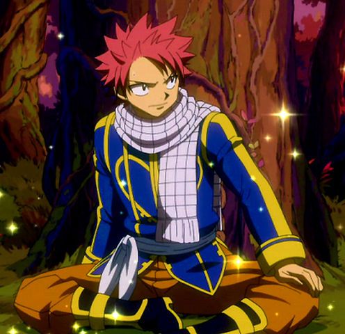 the image shows a male anime character with red hair and blue eyes, sitting with his legs crossed. he is wearing a blue suit with yellow trim, and a white scarf. he is looking to the left and smiling. there is a forest background, and glowing sparkles around him. the character is probably natsu dragneel from the anime series fairy tail. he seems happy and confident, ready for adventure and action.