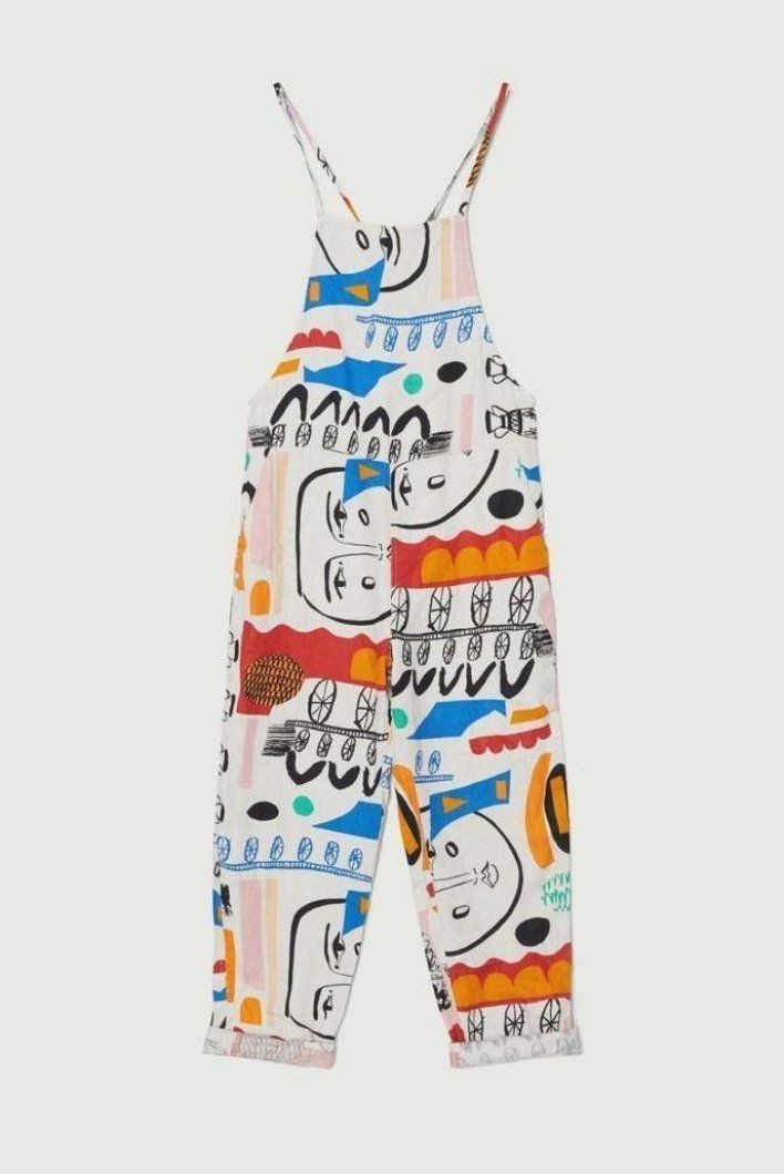 a pair of white overalls with a colorful abstract pattern is displayed against a plain white background. the garment is designed with straps and the legs are cropped at the ankles.