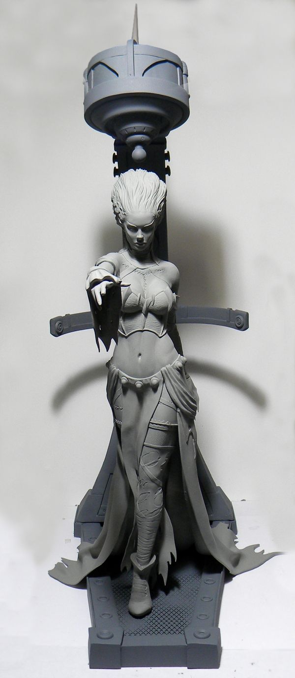 a meticulously crafted gray resin model of a female fantasy figure. she stands on a detailed base, possibly 3d printed, and holds her right hand outstretched as if casting a spell.  the figure is dressed in a long, flowing robe and intricate jewelry, suggesting a sorceress or similar mystical character.