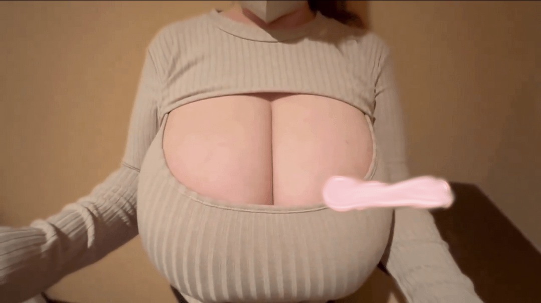 a woman wearing a longsleeved shirt with a large cutout exposing her breasts. she is wearing a mask.