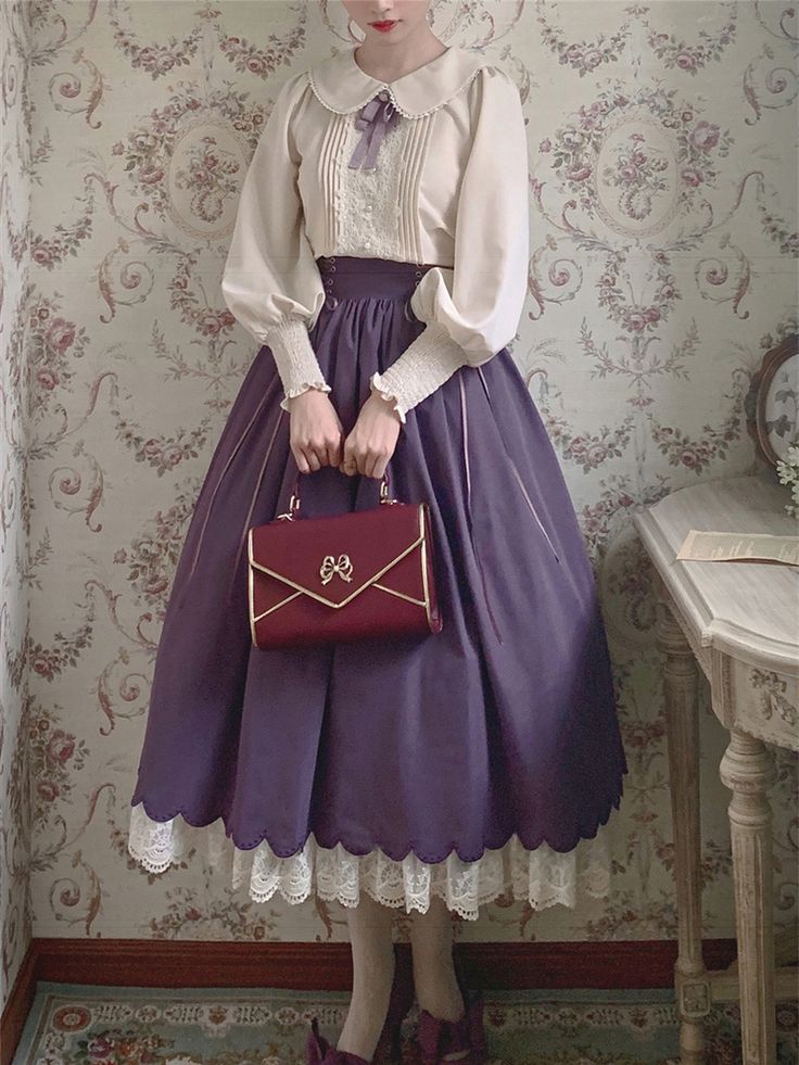 a woman is standing in a room, wearing a classic lolita outfit. she is wearing a white blouse with a peter pan collar and a purple skirt with lace trim. she is also carrying a burgundy handbag. the room is decorated in a vintage style and there is a table in the background.
