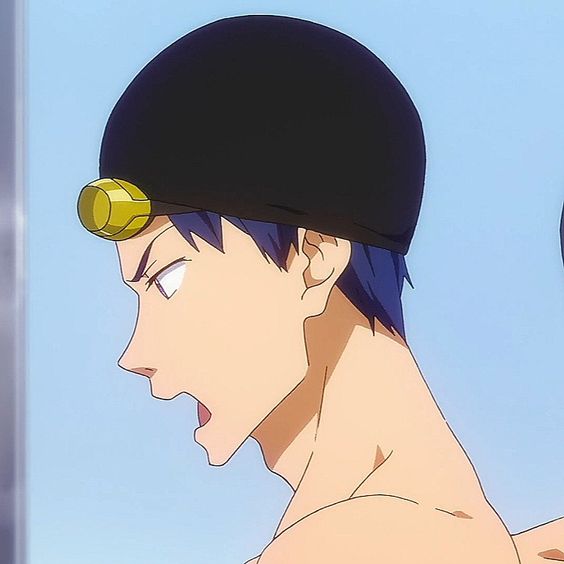 an image of an anime character wearing a black swim cap with a gold detail. he is inside, and the background is light blue. the image is a close up of his face and shoulders as he is turned to the side and talking.