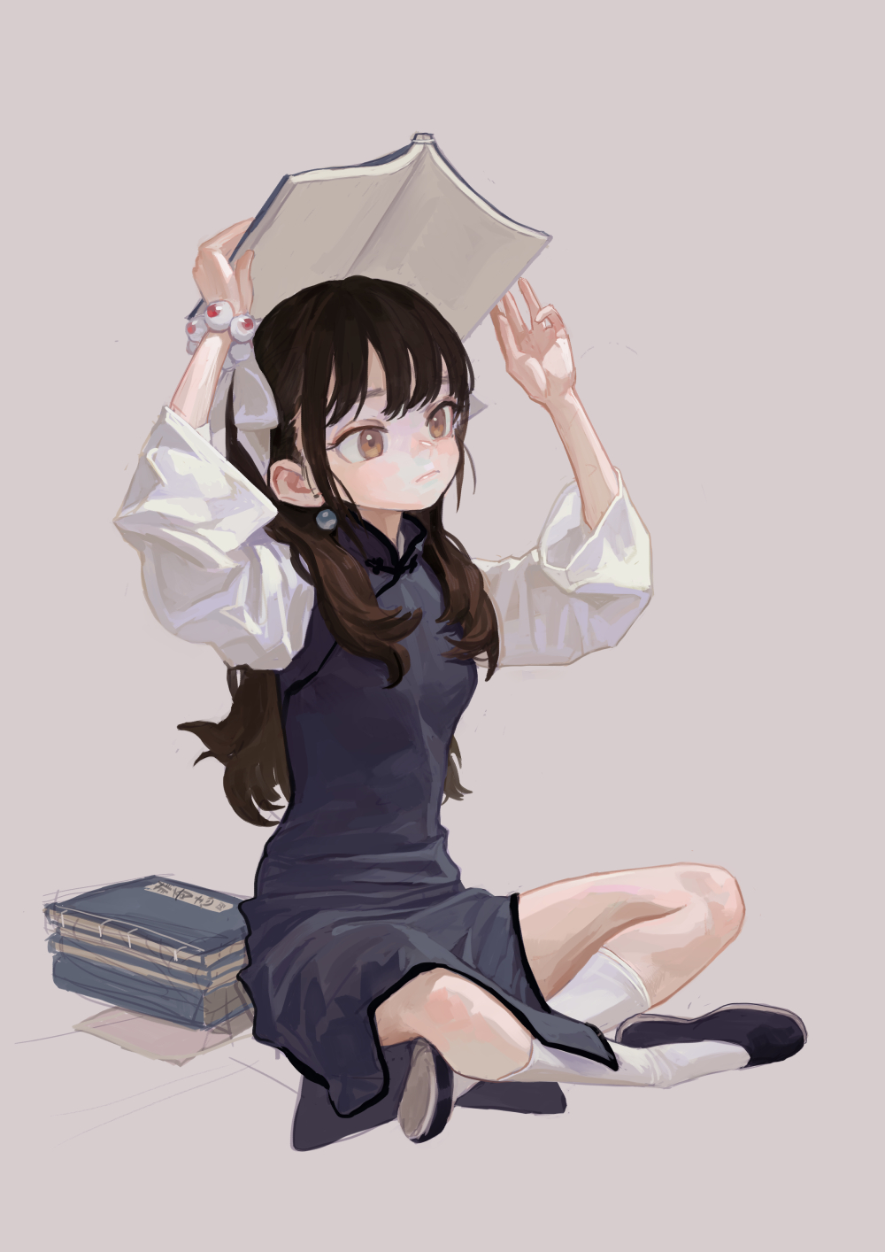 an animestyle image of a girl seated on the floor with her legs crossed. she is wearing a dark blue cheongsam dress, white socks, and dark shoes. she has brown hair and is holding an open book over her head. there is a stack of books to her left. she has a white ribbon in her hair.