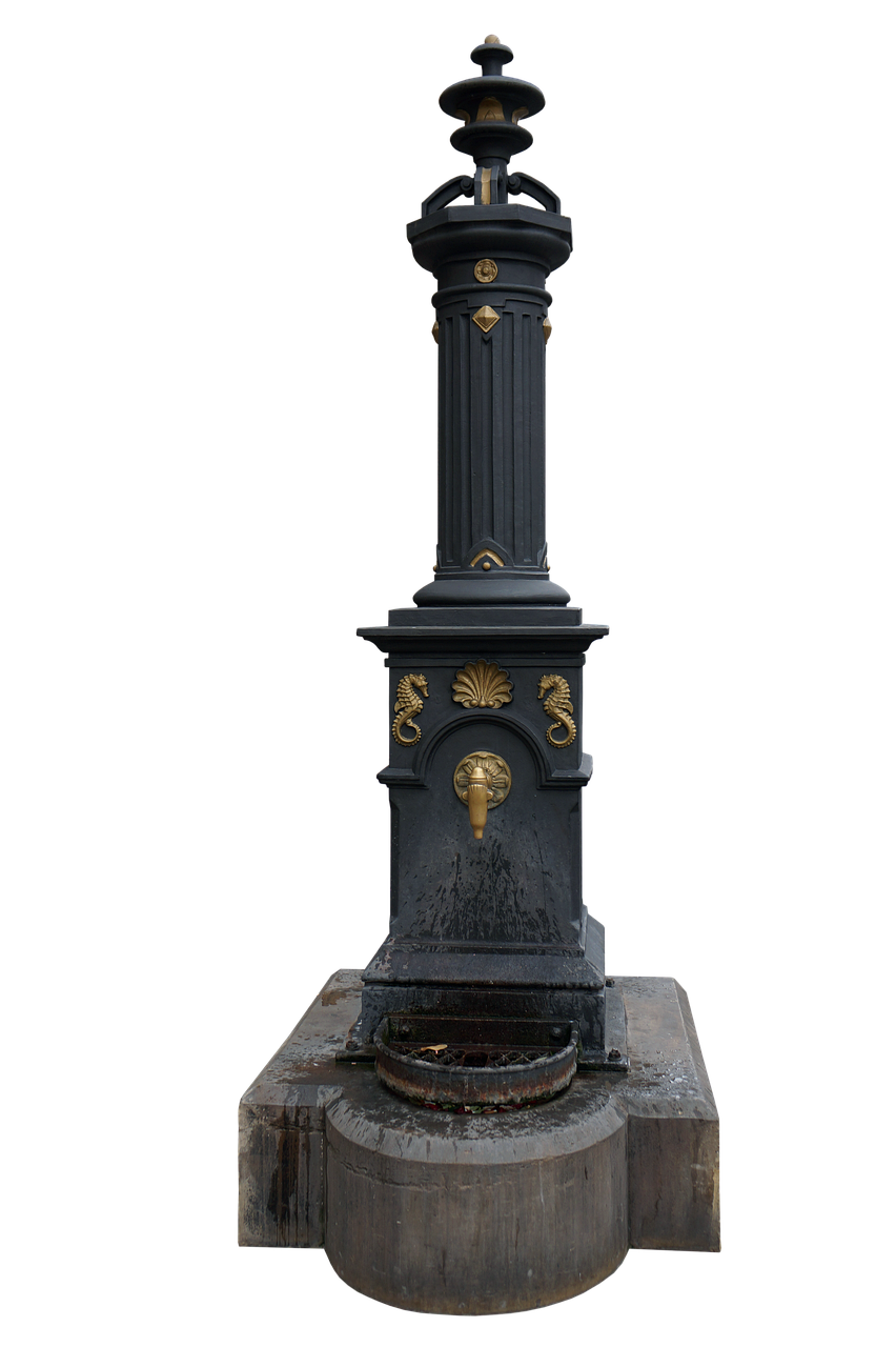 a tall, ornate black water fountain with gold accents stands against a black background. the fountain has a stone base, a bowl for collecting water, and a tall pillar with decorative seahorses, seashells, and other details. a small golden faucet protrudes from the front.