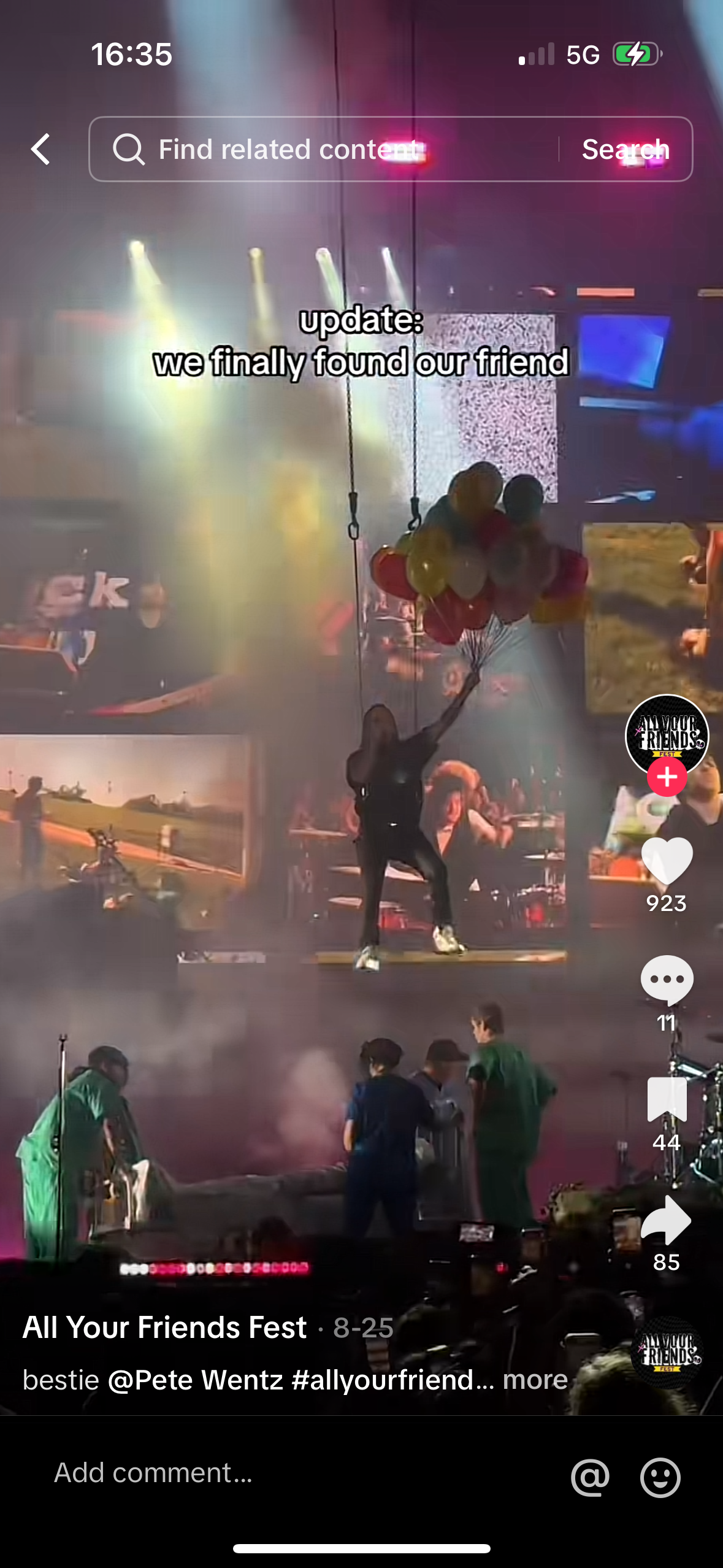 this is a concert photo showing people standing on stage during a music concert. the photo shows a few people performing on a stage in front of a large crowd. there are some balloons in the air, and the stage is lit up with lights. the text overlayed on the photo indicates this is a concert for the band "all your friends fest" and that the person performing is pete wentz.