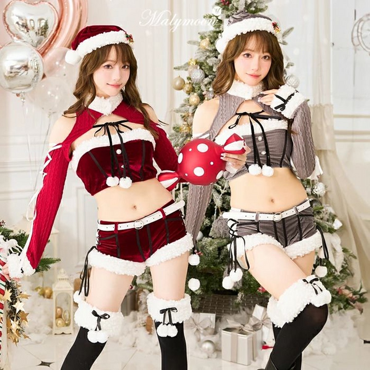 the image showcases two young women in playful and alluring christmasthemed costumes. one woman wears a red velvet santainspired outfit, while the other is in a grey version of the same style.  both outfits include short shorts, cropped tops, fluffy white trim, and pompoms.  they are posing against a backdrop of a decorated christmas tree and heartshaped balloons.  the setting appears to be a professional photography studio. the overall style is festive and cute, with a hint of sexiness. the brand name "malynmoon" is visible in the background.