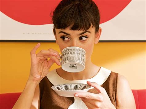 a closeup shot of a young woman with a 1960sstyle bob haircut and bangs, wearing a brown dress with a peter pan collar. she is intensely focused on a small cup and saucer she is drinking from. the cup features a black and white colosseumstyle print. the background features a piece of abstract art with a large red shape against a yellow wall.  she appears calm and contemplative. the overall aesthetic is retro and stylish.