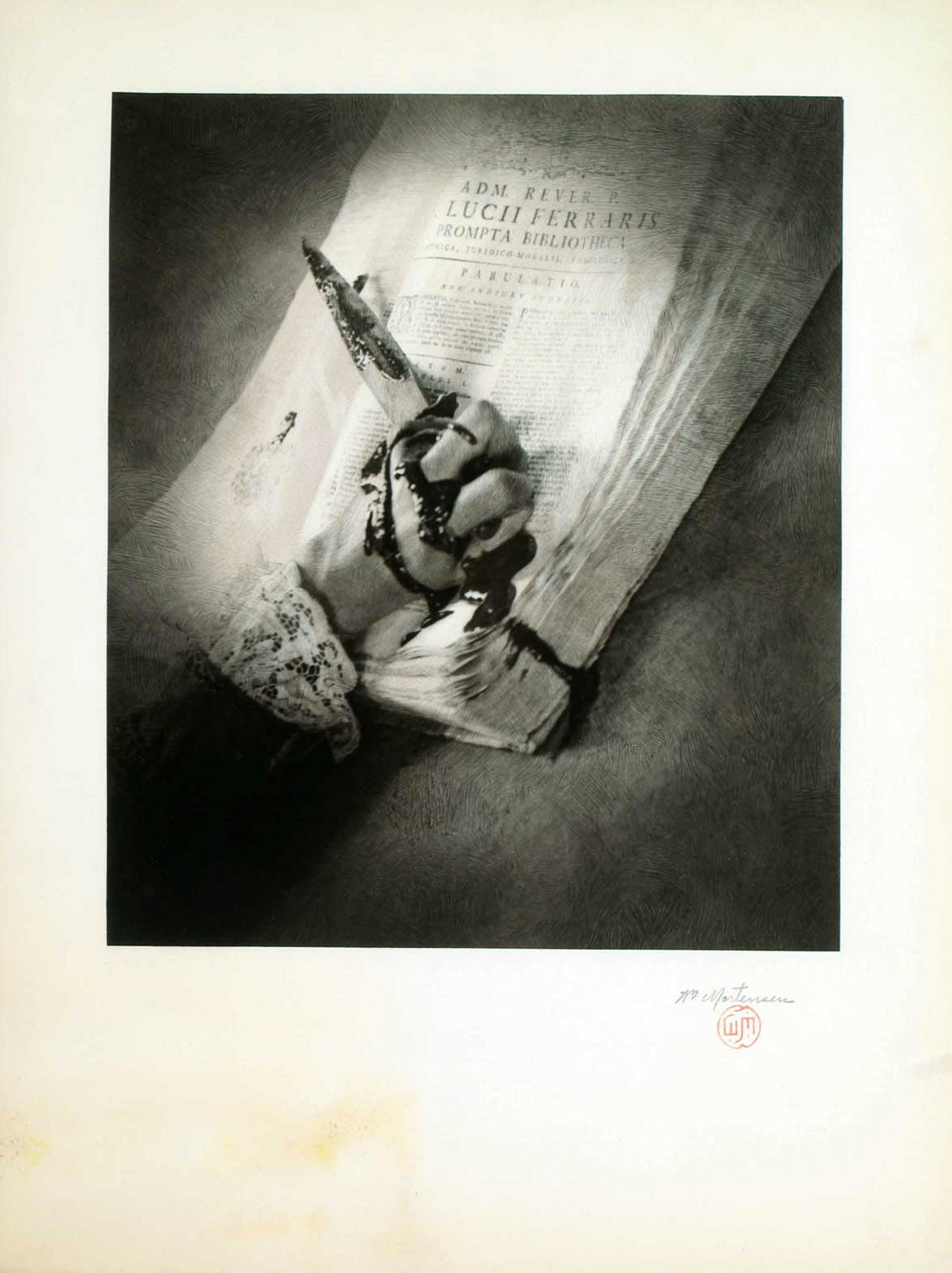 a black and white closeup photograph depicting a hand in lace gloves holding a quill pen, seemingly writing or signing an old book.  the book is open, revealing a title page with text in latin, including the names "admi rivivs" and "lucii ferraris" and the title "prompta bibliotheca".  the overall mood is dark, mysterious, and artistic, with a focus on texture and contrast.  the image has a vintage, possibly antique, feel. the photo is presented on what looks like archival matte paper.  a small, red stamp is visible in the lower right corner.