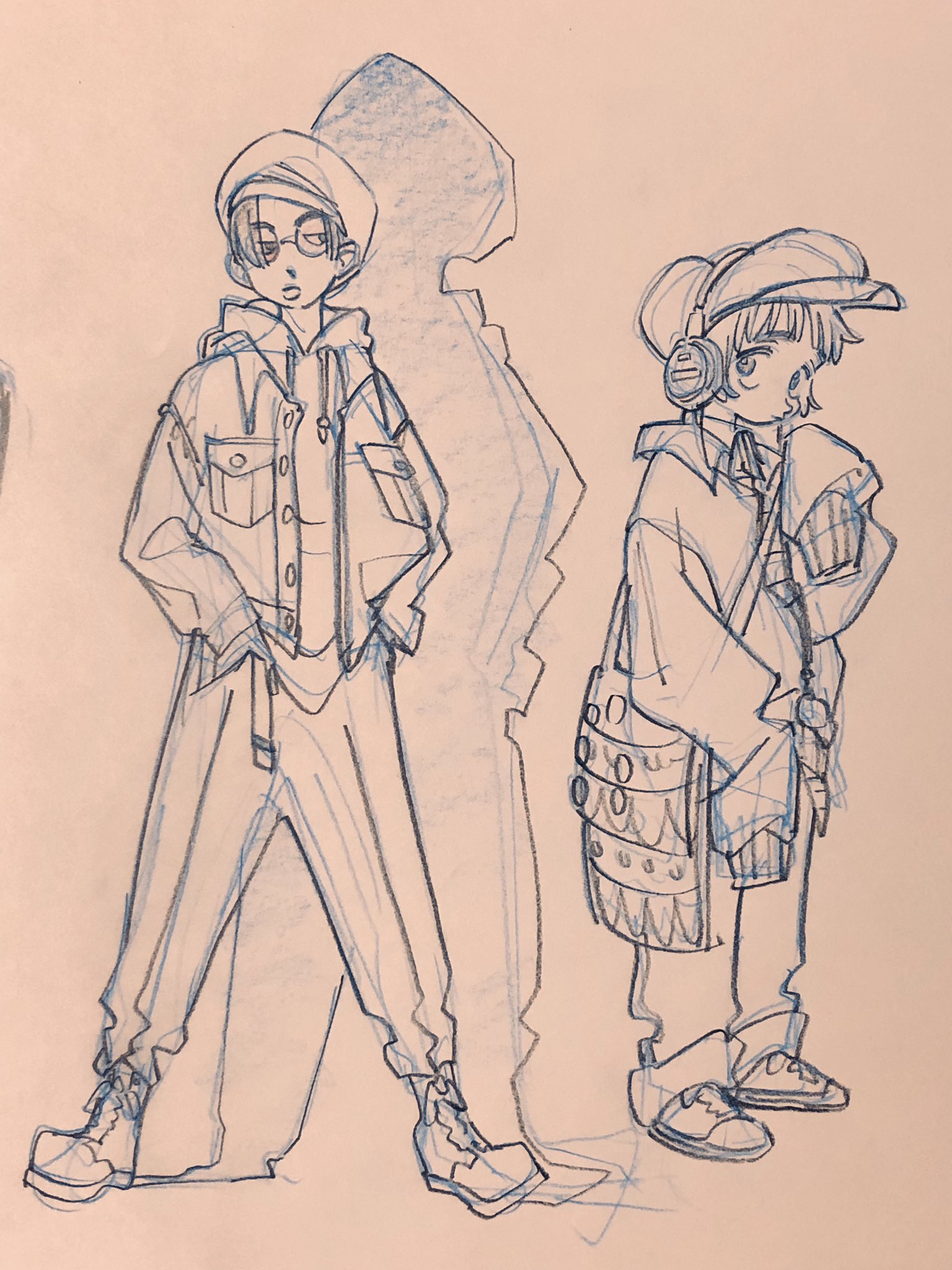 this is a fashion illustration of two figures, drawn in blue pencil on light pink paper. the left figure is taller and has short hair and round glasses.  they are wearing a denim jacket over a hoodie, pants with cargo pockets, and boots. the figure on the right is shorter, wearing a backwards baseball cap, headphones, a hoodie, cargo pants, and sneakers. there is a large bag with circular decorations slung across their right shoulder.