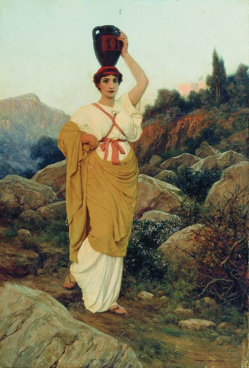 a fulllength oil painting depicts a woman carrying a dark, ornate vase on her head in a classical grecian style. she is positioned in a rocky, hilly landscape. the woman wears a white, draped dress with a yellow shawl wrapped around her body and tied at the waist with a red ribbon. she also wears a red headscarf. her left arm is raised to help steady the vase on her head. the landscape is made up of large rocks, shrubs, and trees with a mountain range visible in the background. the sky is a light, faded color, suggesting either dawn or dusk.