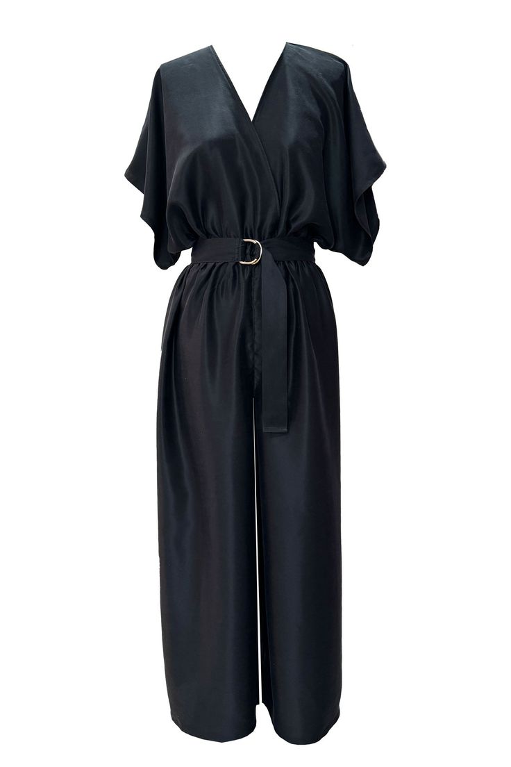 a black satin jumpsuit with a vneck, kimono sleeves and a wide leg. it is belted at the waist with a gold buckle.  the jumpsuit is elegant and formal and would be perfect for a special occasion.