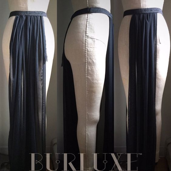 the image shows a fashion item, specifically a dark blue skirt made of sheer fabric. it features a beltlike waistband and long, flowing sections of fabric. the skirt is displayed on mannequins in three different views: front, side, and back. the "burluxe" logo is visible at the bottom of the image.