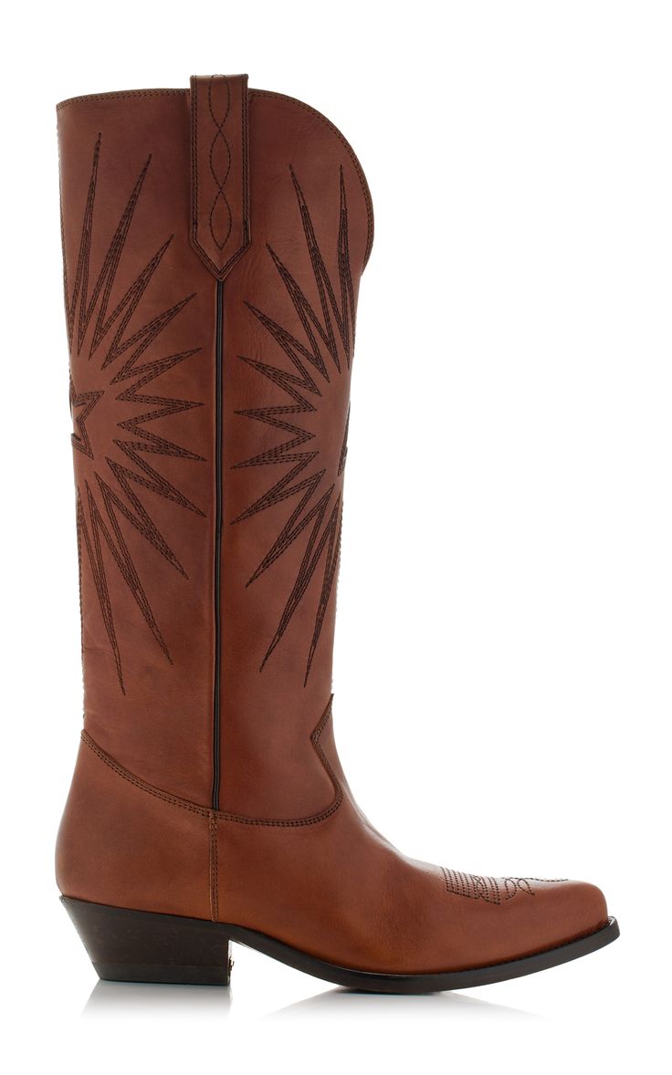 a pair of brown leather women's cowboy boots are shown on a white background. the boots are tall, reaching above the ankle, and have a pointed toe. they are decorated with starburst embroidery on the shaft. the boots are made of leather and have a slight heel.