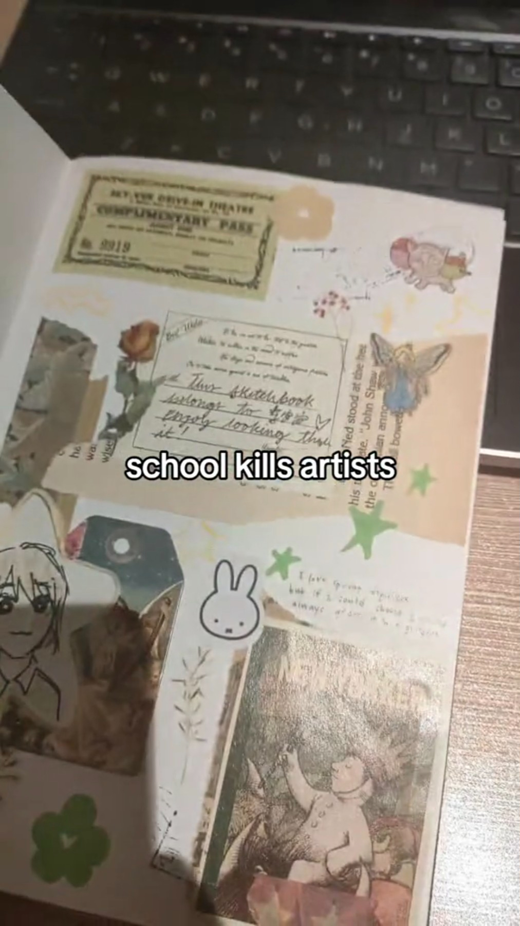 an open notebook laying on a desk.  the pages are filled with writing and various stickers